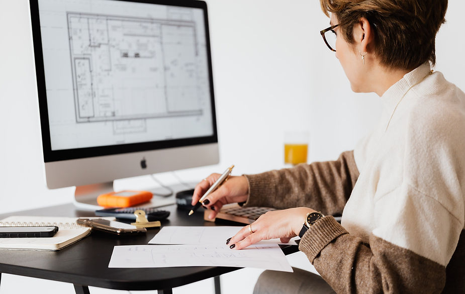 woman reading construction drawings hotel renovation construction drawings